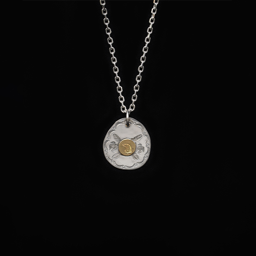 EAGLE HEAD STAMPED OVAL PENDANT (18K GOLD ACCENT)